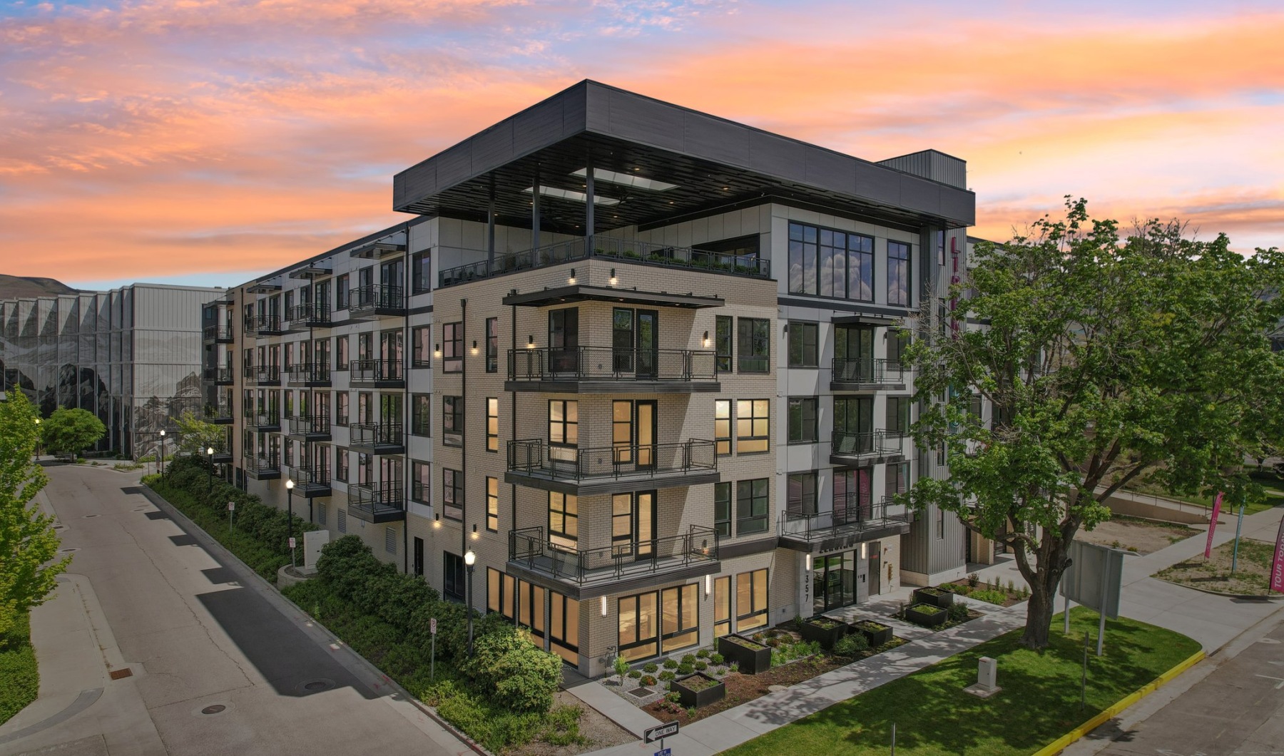 Liberty Duet Apartments, Salt Lake City, Utah, 2 Bedroom Apartments, evening image with lit apartments with a sunset.