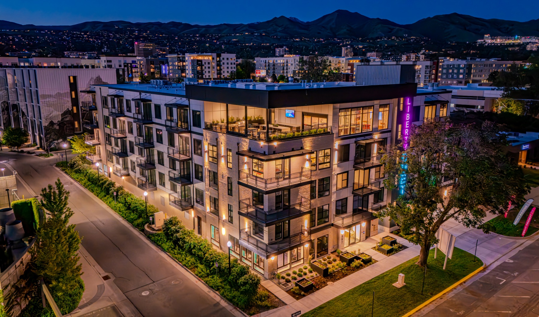 Liberty Duet Apartments, Salt Lake City, Utah, 2 Bedroom Apartments, evening image with lights on and mountains in the background. 