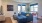 Liberty Duet Apartments, Salt Lake City, Utah, Living Room with couch, table, doors leading to balcony, TV, bistro table. 
